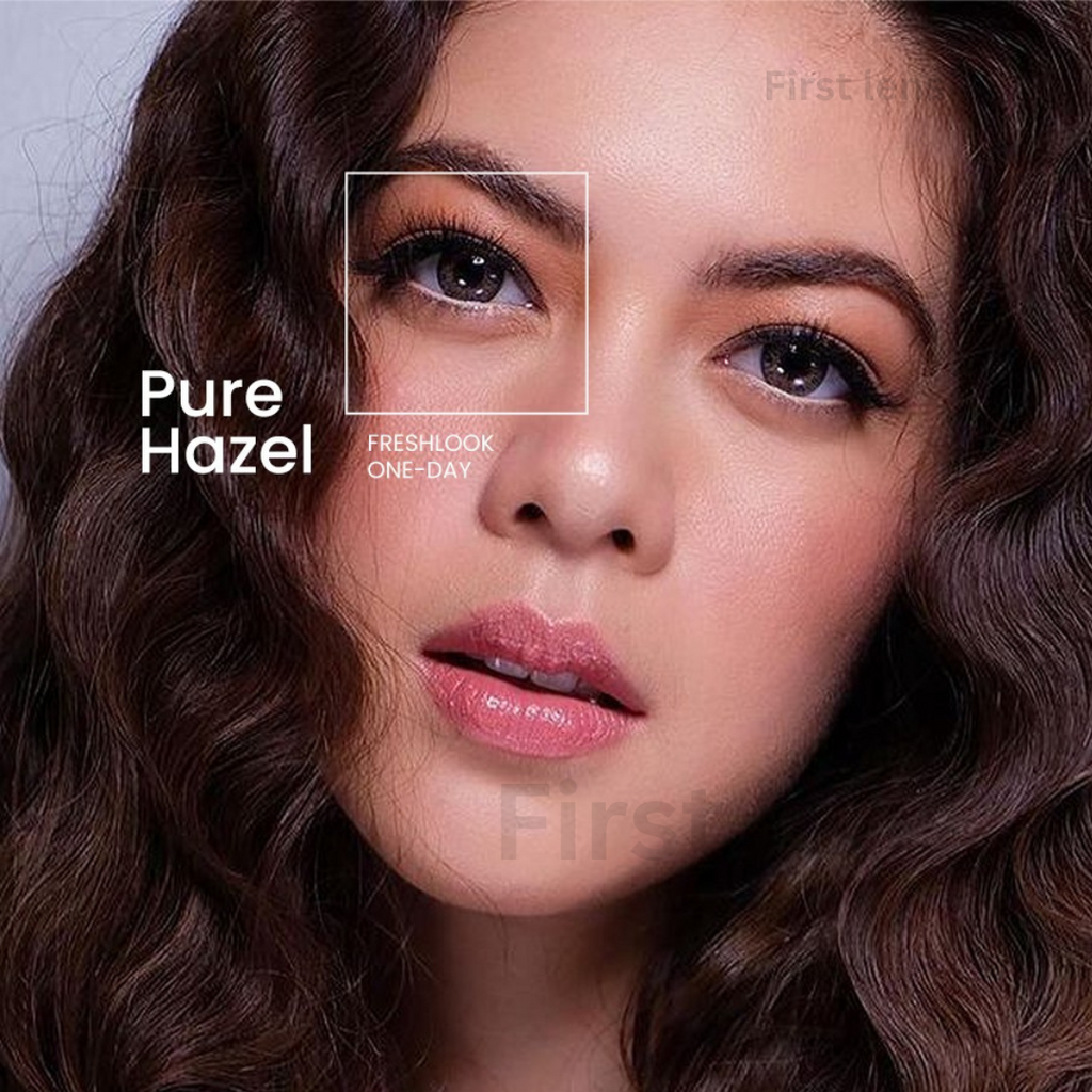 A close-up shot of a person's eyes, one of which is wearing Alcon Freshlook OneDay Color Lenses in the shade Grey.